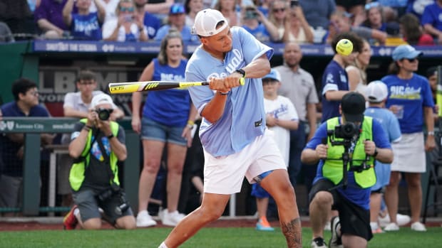 Patrick Mahomes swings the bat during a celebrity softball game.